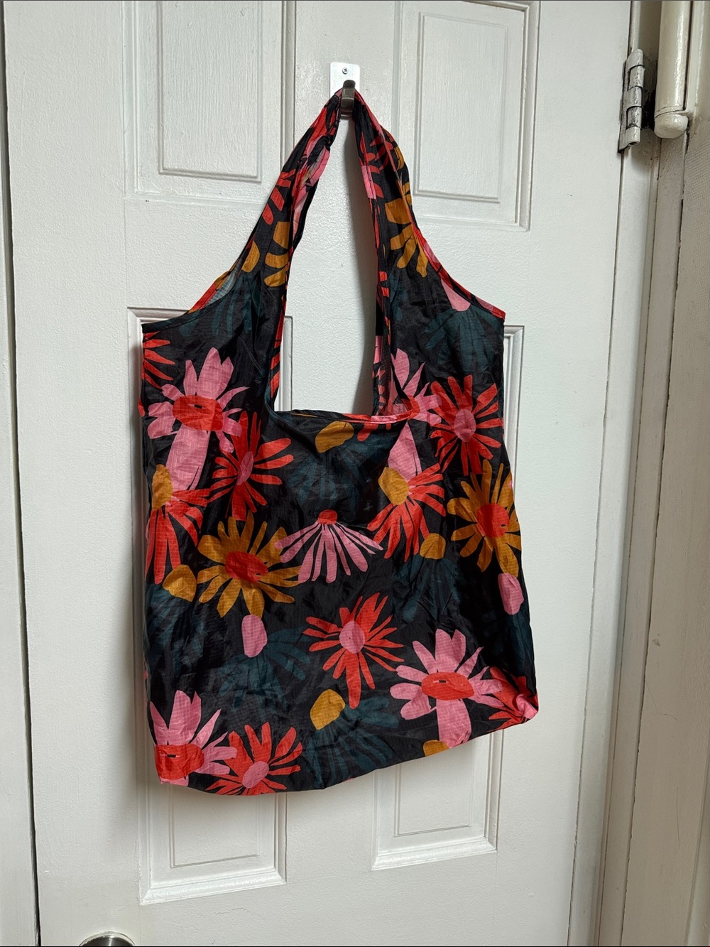 Black Floral Tote Bag with Pink & Orange Flowers fall into pouch